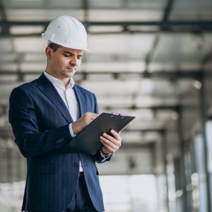 Handsome business man engineer in hard hat in a building